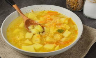 A hearty and delicious homemade soup with lentils and potatoes is ready. Serve with herbs and sour cream!