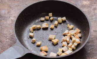 A la mateixa paella, fregiu la cansalada tallada a daus petits.