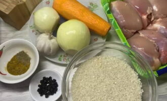 Chicken pilaf is very easy to prepare. Measure out the rice for pilaf and spices. Remove the skin from the carrots using a parser. Remove the top layer from the bulbs.