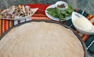 Roll out the dough into a thin layer. Place it in a baking dish.