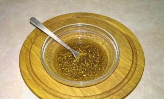 Trasferire la miscela aromatica in una ciotola profonda. Aggiungi qui olio d'oliva, succo di limone, senape in polvere e miele. Mescolare accuratamente.