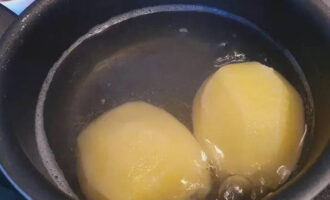 Peel the potatoes. Cook two of them whole.