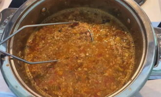 Mash the contents of the pan with a masher and then strain through a sieve.