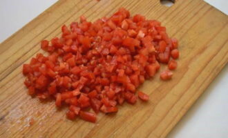 A l'aide d'un couteau bien aiguisé, coupez les tomates en cubes. Nous faisons cela aussi petit que possible.