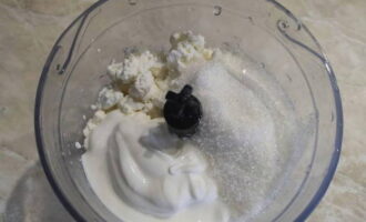 Ora prepariamo la crema di ricotta. Metti la ricotta, lo yogurt, lo zucchero vanigliato e lo zucchero normale rimasto nella ciotola del frullatore.