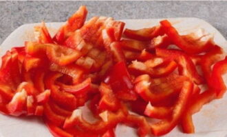 We clean the bell pepper from seeds and membranes, cut into strips or cubes. As you cut, immediately add it to the meat and onions.