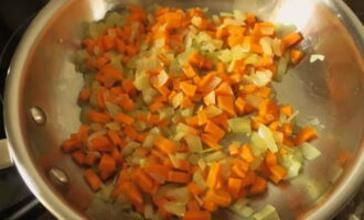 When the onion is translucent, add the diced carrots and chopped garlic.