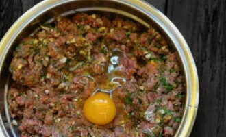 Combine the ingredients with stirring movements, and then carefully beat in the chicken egg. Beat and knead the minced meat thoroughly. White threads should form and the meat should become elastic. This process can take up to 15 minutes.