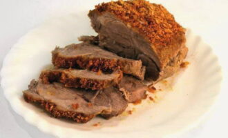 Transfer the baked meat to a plate and cut across the meat fibers into portions.