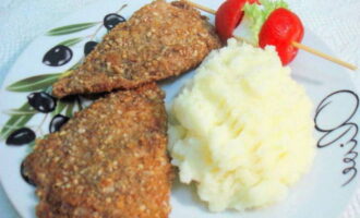 Place tilapia fried in batter in a frying pan onto portioned plates and serve with a side dish and vegetables. Bon appetit!