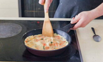 Pour the egg and vegetable mixture into the frying pan. Keep on fire until fully cooked. This will take approximately 5 minutes.