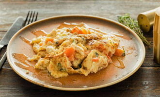 Omelet with vegetables in a frying pan is ready. Place on serving plates and serve!