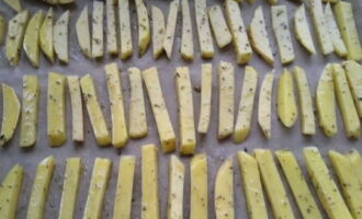 Place the prepared potatoes on parchment paper in a baking dish.