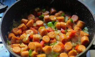 We also add tomatoes and sausages here. Stir and simmer for a couple more minutes.