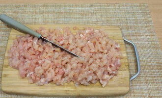 Place the chicken breast on a cutting board and cut it into very small pieces of any shape.