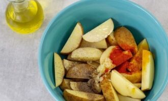 Also add all the prepared spices and salt, add vegetable oil. Gently toss the potato wedges until they are evenly coated with the spices and oil.