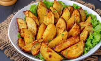 For a beautiful presentation, you can place lettuce leaves on a flat dish, and only then place potato wedges baked with garlic on them. Bon appetit!