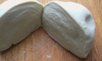 Divide the rested dough into two equal parts.