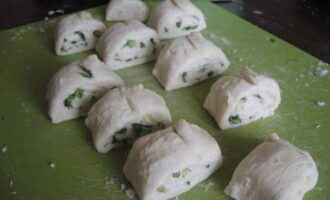 Roll the dough into a tight roll. Cut it into small pieces of equal thickness.