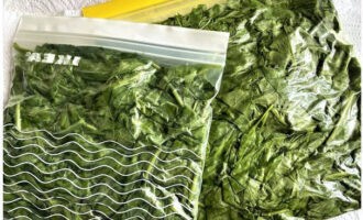 Place the prepared spinach compactly in zip bags or regular freezer bags, removing as much air as possible. Then seal the bags tightly and immediately transfer them to the freezer, where the spinach can be stored for up to 12 months.