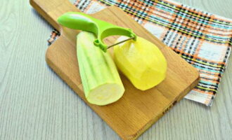 To prepare delicious pancakes from zucchini and potatoes in a frying pan, peel the vegetables using a regular vegetable peeler and rinse with cold water.