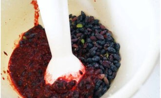 Place the berries in a deep bowl and puree them using a masher or immersion blender.