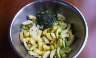 Place chopped garlic and dill into the preparation.