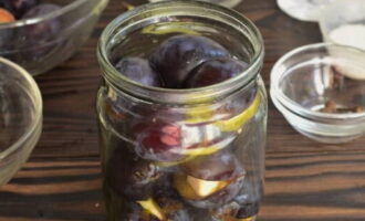 Place the plums in a sterilized small jar.