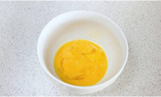 Mix two chicken eggs in a bowl with a whisk or fork.