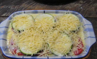 Cover again with zucchini slices. Pour over the sauce and cover with grated cheese.