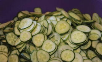 Place the cucumber slices in a large, deep container.