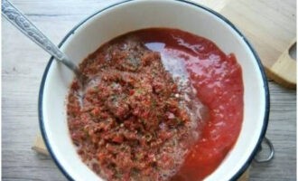 Pour the rolled mixture into a container with tomatoes.