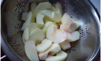 Dip the fruit in hot water for a few seconds and then discard it in a colander. This will allow the apples to retain their light color.