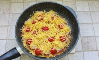 After grating the cheese, scatter it over the tomato layer.