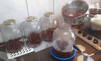 Then re-fill the cherries in the jars with boiling syrup and immediately seal them with lids.