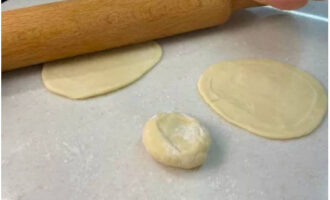 Roll out each piece of dough into a thin circle.