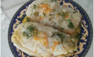 Classic cabbage rolls made from fresh cabbage with minced meat and rice in a pan are ready. Place on plates and serve!