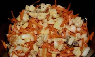 Peel and rinse vegetables. Cut the carrots into thin strips and the onion into thin quarter rings. After 15 minutes, add chopped vegetables to the fried chicken fillet and continue frying for the same amount of time.