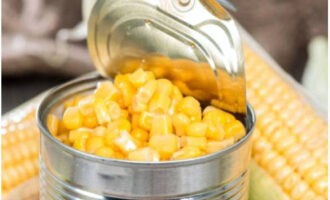 Drain the liquid from a can of canned corn.