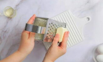 Three pre-frozen butter on a borage grater.