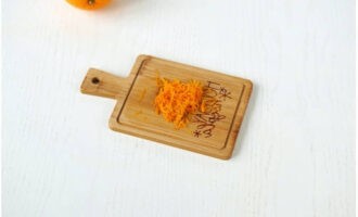 Remove the zest from a washed and dried orange.