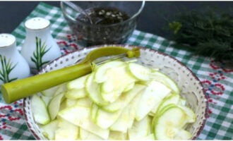 Spoel de courgette af onder stromend water en draai hem met een dunschiller in plakjes.