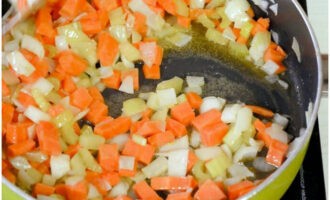 Cut carrots, onions, celery and garlic into small cubes. Simmer vegetables until soft in olive oil and butter.