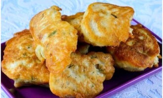 Fried fish in batter in a frying pan is ready. Serve and enjoy!