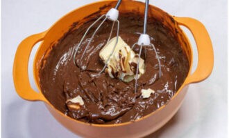 Then add soft butter to the chocolate-cream mixture. Mix the ganache on low speed mixer.