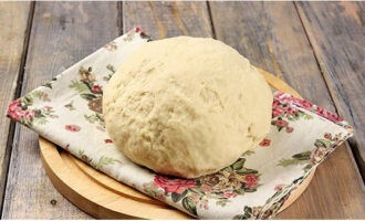 Knead the dough until the product stops sticking to your palms. Cover with a linen towel and leave in a warm place for an hour, then knead and let sit for another 30 minutes.