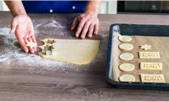 Cut out cookies from the dough and place them on a baking sheet with parchment.