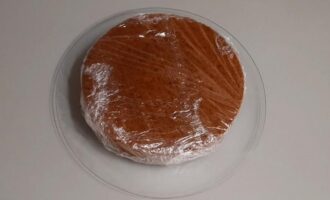 Wrap the prepared fluffy chocolate sponge cake in cling film, place in the refrigerator for 4 hours, which will evenly distribute the moisture, and begin assembling the cake. Delicious and successful baking!