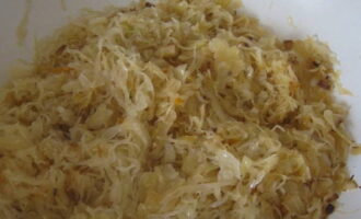 Ilagay ang hugasan na sauerkraut sa isang kawali na may mga sibuyas.