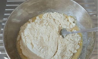 Crack the eggs and add vanilla, salt and sifted flour.